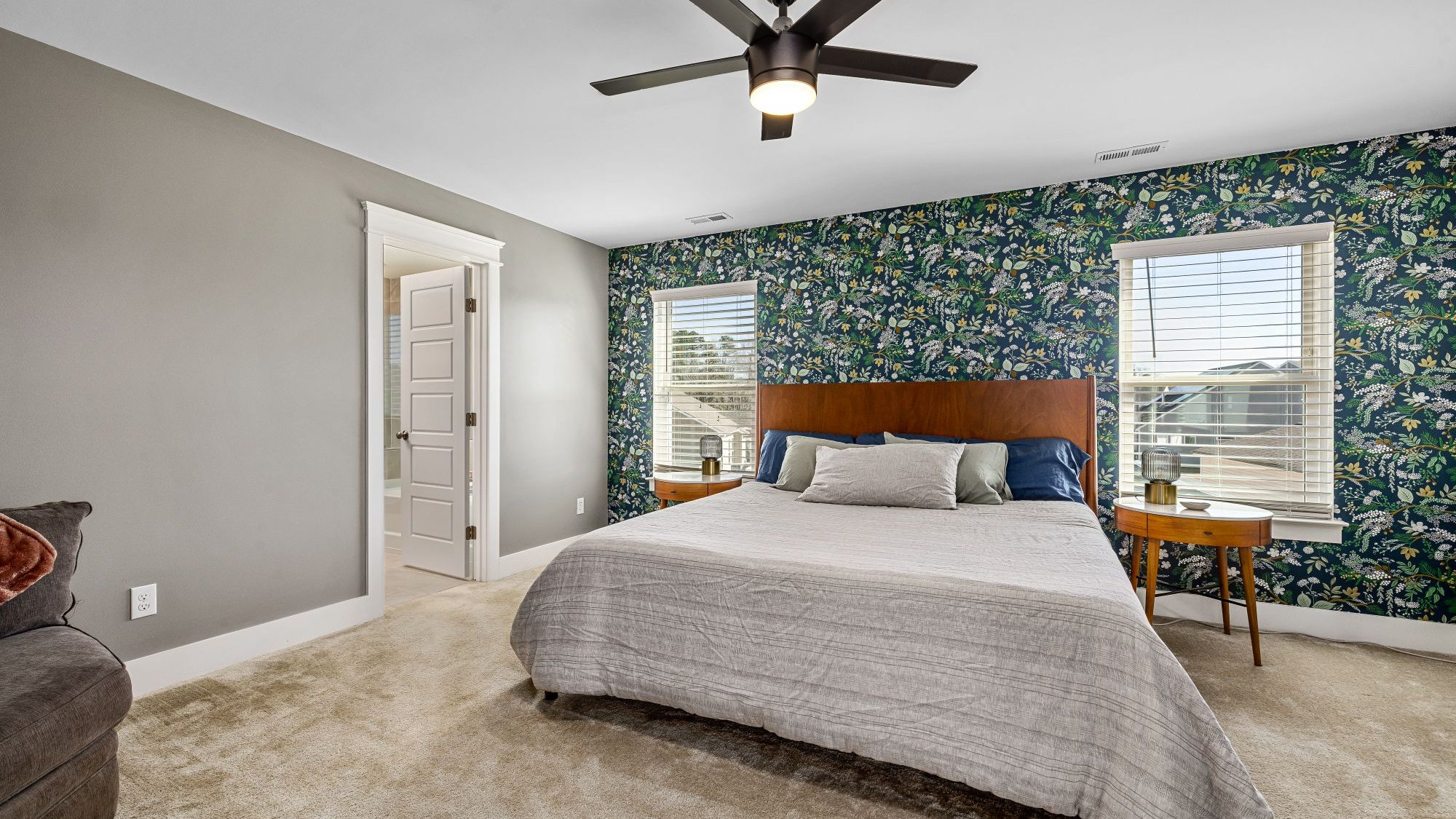 Elegant navy botanical-print wallpaper bedroom with warm brass accents, a fully installed feature wall by Mount Vernon Wallpaper Installer